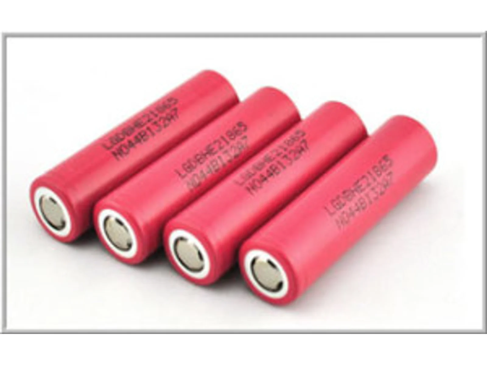 Four pink LG HE2 cylindrical cells on a white background